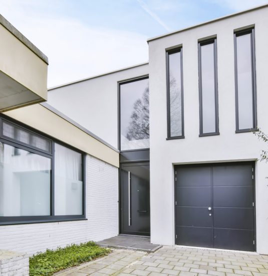 The entrance part of the house is in a minimalist style with a black door